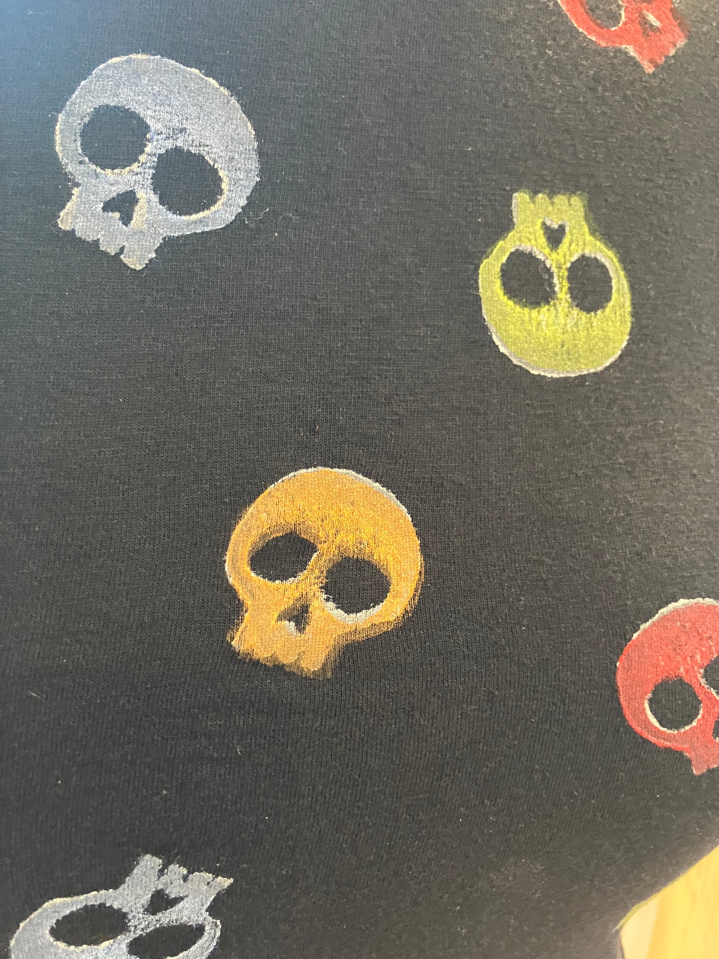 Black T with multi colored skulls